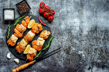 raw salmon skewers on skewers on a stone background with copy space for your text .Raw seafood on skewers