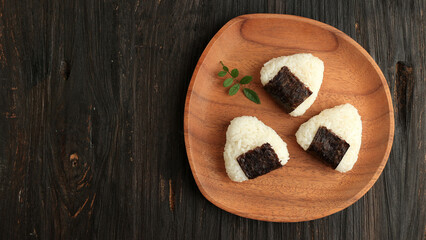 Japanese Triangle Onigiri on Wooden Plate