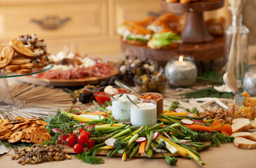Elaborate charcuterie table set up with meats, bread, cheese, nuts, and fruit.