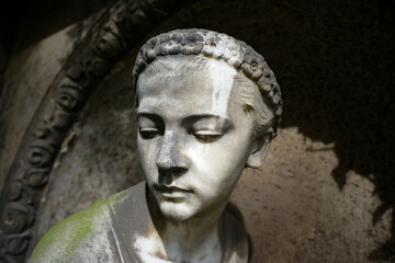 portrait of a weathered but beautiful woman grave figure on the melaten cemetery in cologne