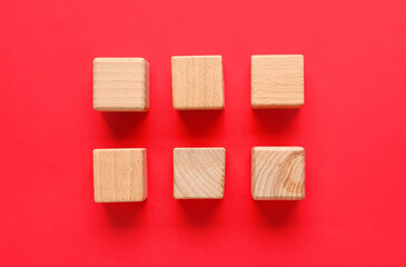 Wooden cubes with check marks on red background