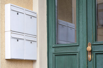 Obraz na płótnie Canvas View of white mailboxes on building wall