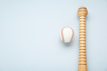 Wooden baseball bat and ball on light grey background, flat lay. Space for text