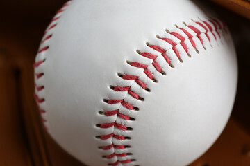 Leather baseball glove with ball, closeup. Sportive equipment