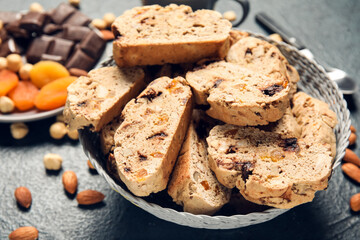 Bowl with delicious biscotti cookies on grunge background