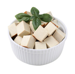 Bowl of delicious smoked tofu cubes with basil isolated on white
