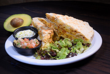 Mexican food tacos, fried chicken, greens, mango, avocado, pepper, red cabbage in tex-mex mix tortillas