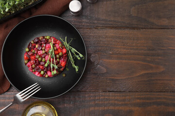 Delicious vinaigrette salad on wooden table, flat lay. Space for text