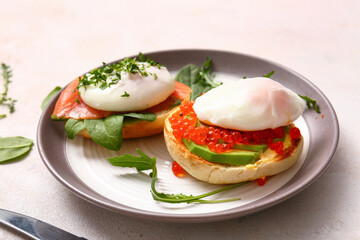 Plate with tasty eggs Benedict on white table, closeup