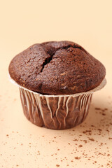 Tasty chocolate cupcakes on beige background