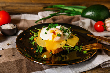 Plate with tasty egg Benedict on table