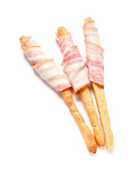 Tasty Italian Grissini with bacon on white background