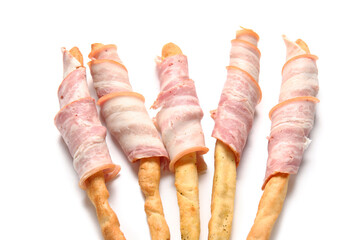 Tasty Italian Grissini with bacon on white background, closeup