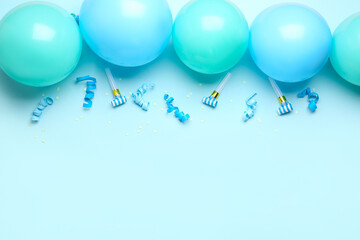 Fototapeta na wymiar Blue balloons, ribbons, party whistles and serpentine on color background