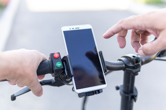 Man using a phone while riding a bike, image of dangerous bend. copy space