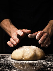 Baker or cook kneads an organic yeast dough