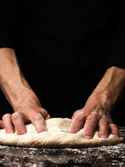 Baker or cook kneads an organic yeast dough, traditional handwork