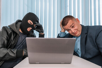 extortionist thief demands money in the businessman's office. Theft of personal data. Bank robbery....