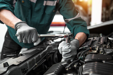 Car care maintenance and servicing, Hand technician auto mechanic using the wrench to fix car or...