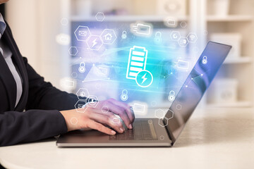 Hands working on laptop with digital icons