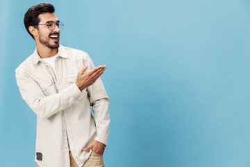 Portrait of a stylish man smile with teeth and happiness in glasses for farsightedness and myopia, on a blue background in a white T-shirt, space space