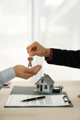Businessman, insurance sales agent handing over house and car keys to customer in trading or...