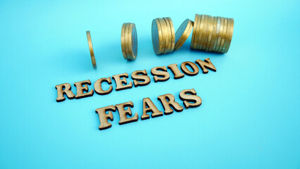 Recession fear symbol. Recession Fear concept words on wooden blocks against beautiful background of coins money. Business fear and recession concept. Copy space.