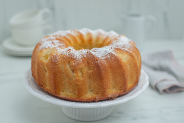 Lemon bundt cake drizzled with powdered sugar glaze