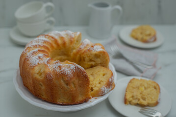 Lemon bundt cake drizzled with powdered sugar glaze