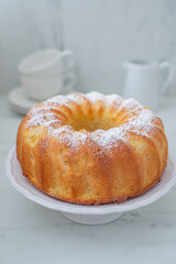 Lemon bundt cake drizzled with powdered sugar glaze