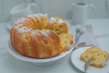 Lemon bundt cake drizzled with powdered sugar glaze