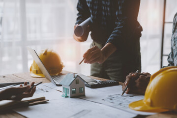 Architectural engineer team meeting house plan writing Housing and work for architectural projects and on-site engineering tools technical construction concept.