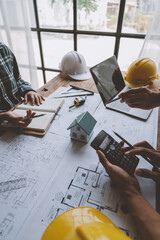 Architectural engineer team meeting house plan writing Housing and work for architectural projects and on-site engineering tools technical construction concept. © Phimwilai