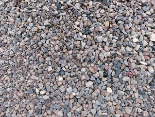 Grey pebbles flat lay with warm evening light. Little stones pattern.