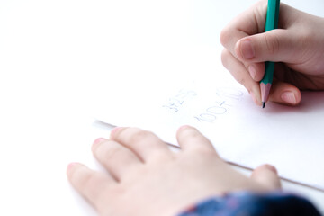 Close-up of children's hands. Prewriting practice to prepare the hand for writing numbers.