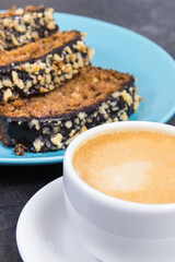 Zucchini dough on blue plate and cup of white coffee. Delicious dessert