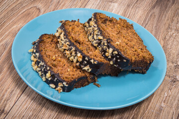 Pastry made of zucchini with nuts and raisin on plate. Delicious dessert