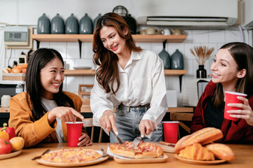 Group of friends drinking beverage and cutting slice of italian