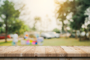 Empty wooden table top and Abstract blurred light bokeh and blur background of garden trees in sunlight. product display template with copy space.