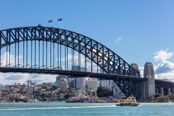Naklejka premium View of the famous Sydney Harbour Bridge with a Sydney ferry in NSW Australia