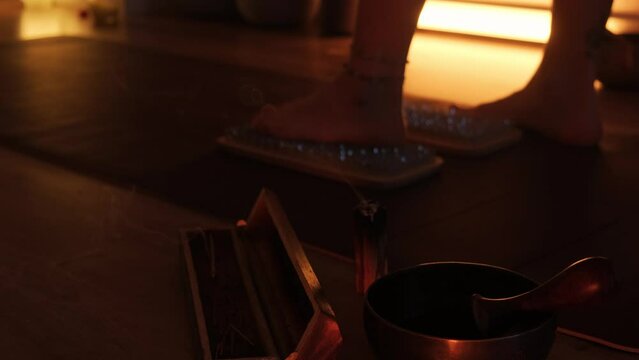 Women's feet stepping on sharp nails for meditation, sadhu wooden board. Yoga practice