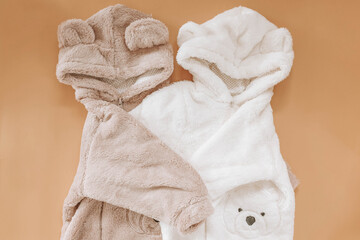 Jumpsuits for newborns in the shape of bears on a beige background