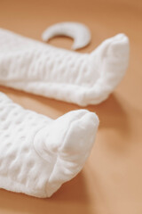 White jumpsuit for a girl or a boy on a beige background. clothes for the newborns