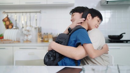 Asian single father and son hugging each other before going to school. Happy family concept. Single father concept