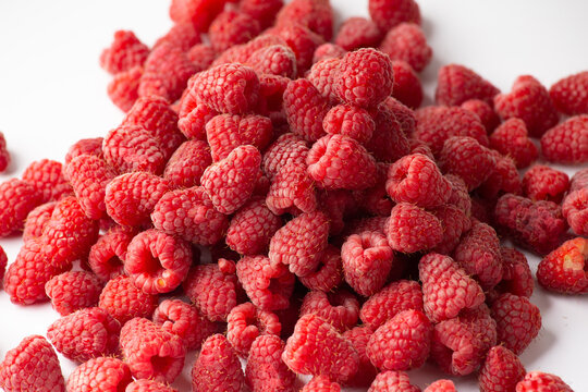 Pile of ripe rasberries isolated on white background