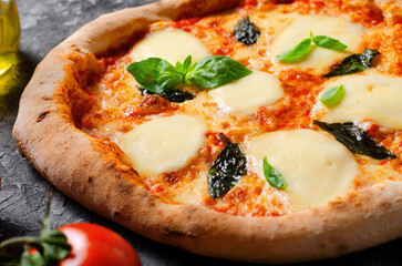 Italian Pizza Margherita with Mozzarella Cheese and Basil Leaves on Dark Background, Freshly Baked Pizza