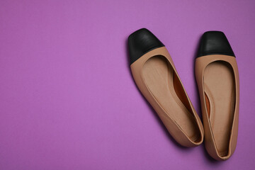 Pair of new stylish square toe ballet flats on purple background, flat lay. Space for text