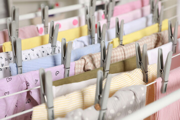 Fototapeta na wymiar Clean laundry hanging on drying rack, closeup