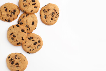 Many delicious chocolate chip cookies on white background, flat lay. Space for text