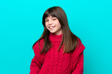 Little caucasian girl isolated on blue background laughing